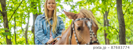 Beautiful woman riding a horse in countryside BANNER, LONG FORMAT 87683774