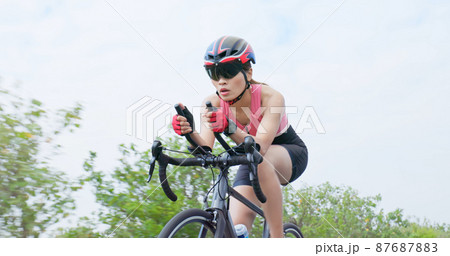 Asian young woman ride bicycle Asian young woman ride bicycle 87687883