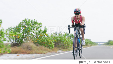 Asian young woman ride bicycle Asian young woman ride bicycle 87687884