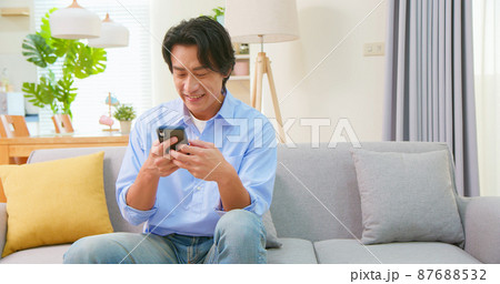asian man use smart phone asian man use smart phone 87688532