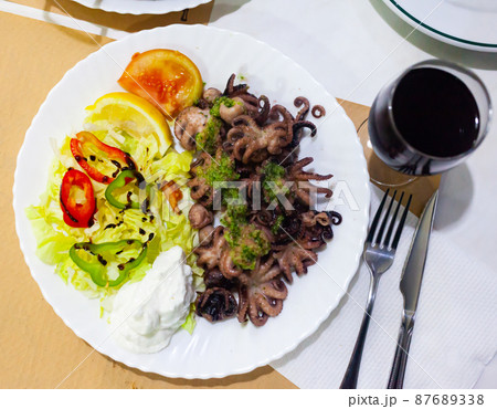 Baby octopus with salad 87689338