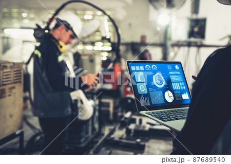 Factory workers working with adept robotic arm in a workshop 87689540