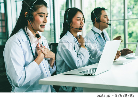 Doctor team wearing headset talking actively on video call in hospital clinic 87689795