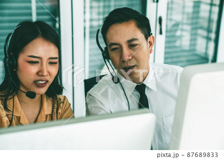 Business people wearing headset working actively in office Business people wearing headset working actively in office 87689833