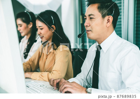 Business people wearing headset working actively in office Business people wearing headset working actively in office 87689835