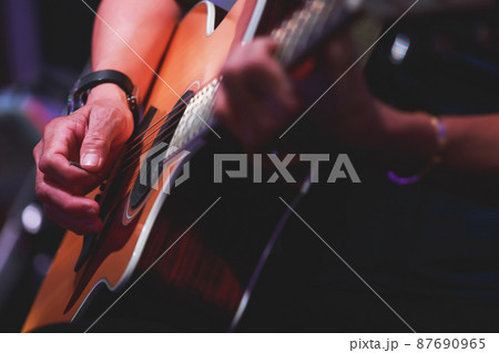 Close up of Man hands playing on acoustic Guitar. Close up of Man hands playing on acoustic Guitar. 87690965