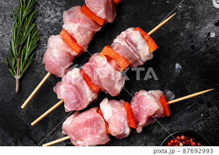 Raw shish kebab. Barbecue Meat Spices and Herbs, top view flat lay, on black dark stone table background 87692993