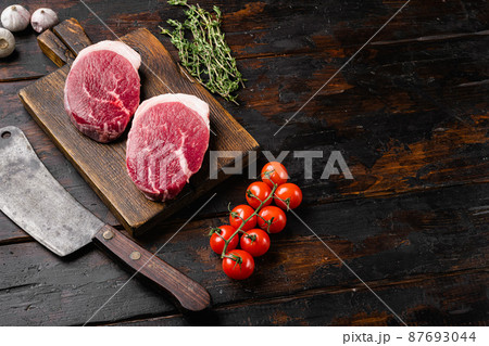 Raw beef meat cut, on old dark wooden table background, with copy space for text Raw beef meat cut, on old dark wooden table background, with copy space for text 87693044