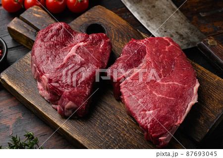 Raw seasoned rump steaks beef meat, on old dark wooden table background Raw seasoned rump steaks beef meat, on old dark wooden table background 87693045