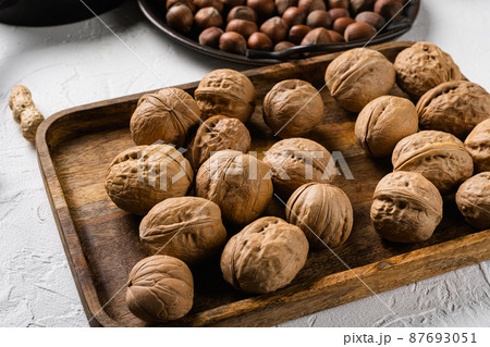 Walnut whole nut, on white stone table background Walnut whole nut, on white stone table background 87693051