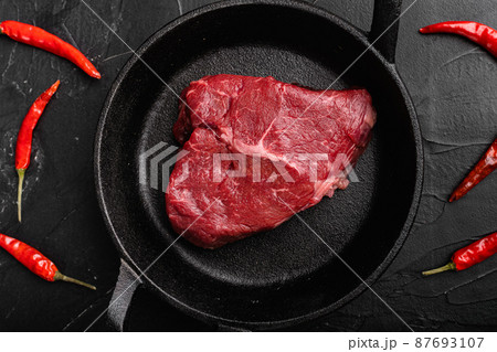 Raw cap rump steak, on black dark stone table background, top view flat lay Raw cap rump steak, on black dark stone table background, top view flat lay 87693107