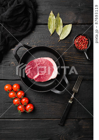 Raw beef steak, on black wooden table background, top view flat lay Raw beef steak, on black wooden table background, top view flat lay 87693119