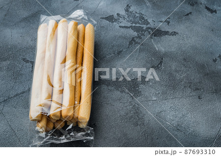 Breadsticks with olive oil, on gray background with copy space for text Breadsticks with olive oil, on gray background with copy space for text 87693310