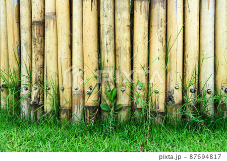 Old brown tone bamboo simple wall or Bamboo fence texture background for exterior design vintage tone. Brown bamboo stick pattern backdrop. Local area urban house protection from thief. Old brown tone bamboo simple wall or Bamboo fence texture background for exterior design vintage tone. Brown bamboo stick pattern backdrop. Local area urban house protection from thief. 87694817