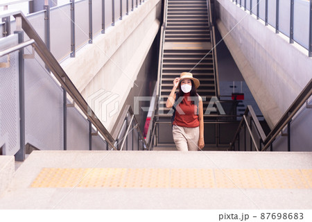 Woman passenger walking on staircase at train station,Transport insurance concept 87698683