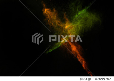 Freeze motion of colorful dust explosion on black background for Happy Holi 87699702