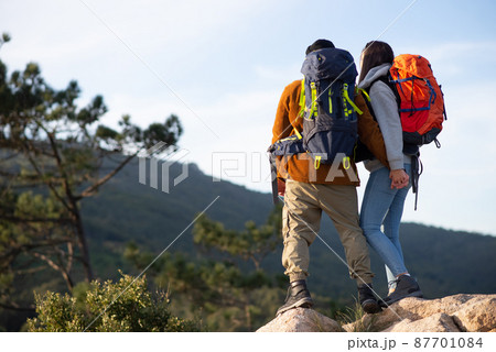 Back view of lively friends hiking Back view of lively friends hiking 87701084