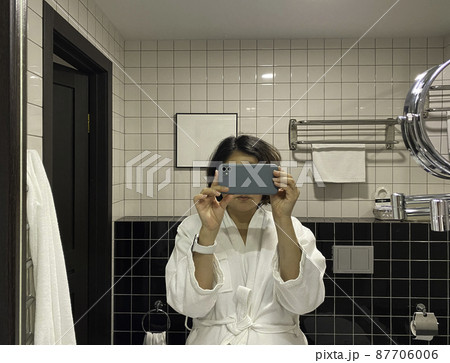 Girl taking a photo in the bathroom. Modern bathroom interior. Girl taking a photo in the bathroom. Modern bathroom interior. 87706006