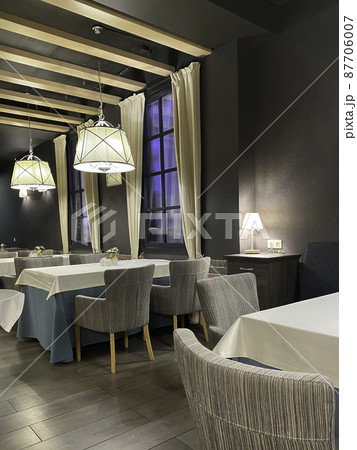 beautifully tables at evening in restaurant. Empty tablescloths 87706007