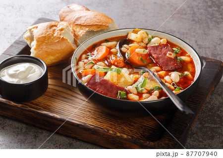 Babgulyas hungarian Soup With Beans, meat and vegetables closeup in the plate. Horizontal Babgulyas hungarian Soup With Beans, meat and vegetables closeup in the plate. Horizontal 87707940