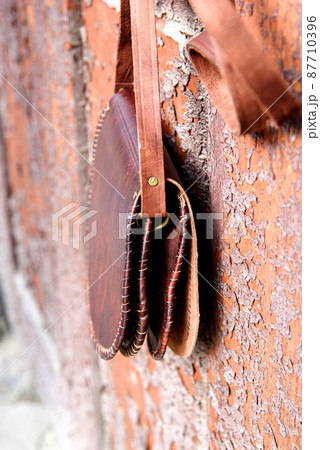 small brown women's leather bag with a carved pattern. selective focus small brown women's leather bag with a carved pattern. selective focus 87710396