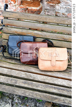 Set of hand made leather handbags . Multi colored. Leather craft. Selective focus 87710423