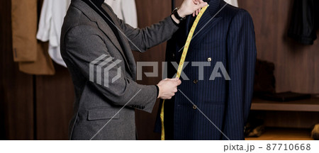 man taking measures from jacket man taking measures from jacket 87710668