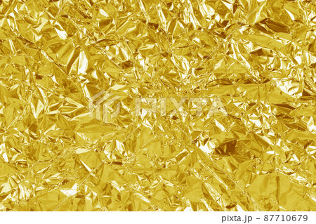 Gold foil leaf shiny texture, abstract yellow wrapping paper for background and design art work. Gold foil leaf shiny texture, abstract yellow wrapping paper for background and design art work. 87710679