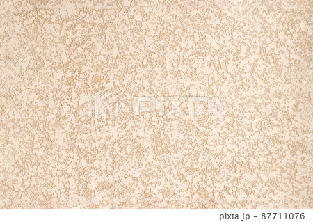 Rough plastered surface. Beige peach abstract background with heterogeneous texture. Rough plastered surface. Beige peach abstract background with heterogeneous texture. 87711076