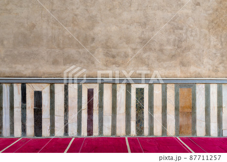 Old grunge stone wall decorated with colorful marble pattern 87711257