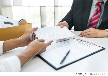 Hand of employer filing final remuneration after employee to write a document letter of resignation, resign concept 87712273