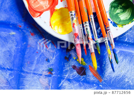 Top view of painters brushes on plastic palette with colorful watercolour. Copy space Top view of painters brushes on plastic palette with colorful watercolour. Copy space 87712656
