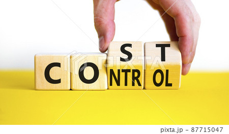 Cost control symbol. Businessman turns wooden cubes and changes the concept word Cost to Control. Beautiful yellow table white background, copy space. Business cost control concept. 87715047