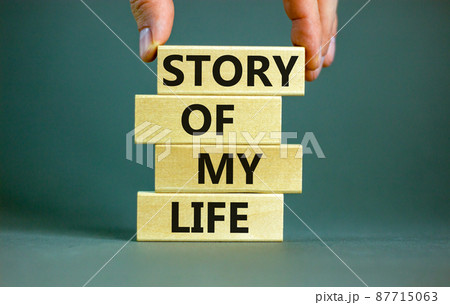Story of my life and storytelling symbol. Concept words Story of my life on wooden blocks. Businessman hand. Beautiful grey table grey background. Story of my life business concept. Copy space. Story of my life and storytelling symbol. Concept words Story of my life on wooden blocks. Businessman hand. Beautiful grey table grey background. Story of my life business concept. Copy space. 87715063
