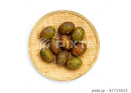 Hog plum in bamboo weave plate on white background Hog plum in bamboo weave plate on white background 87715625