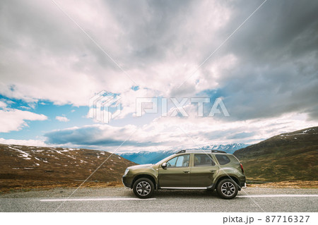 Aurlandsfjellet, Norway. Car SUV Parked Near Aurlandsfjellet Scenic Route Road In Summer Norwegian Landscape. Natural Norwegian Landmark And Popular Destination 87716327