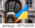 Ukrainian flag waved in Duomo Square in a protest against Russia invasion, Milan 87716456