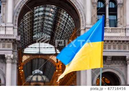 Ukrainian flag waved in Duomo Square in a protest against Russia invasion, Milan Ukrainian flag waved in Duomo Square in a protest against Russia invasion, Milan 87716456