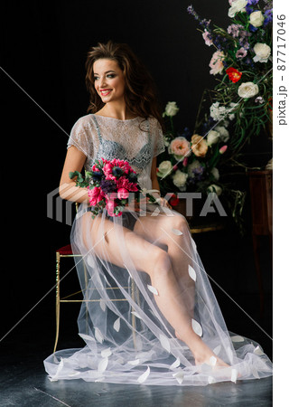 Bride in a white wedding dress in the interior of a Villa at a wedding. Morning of the bride. Bride in a white wedding dress in the interior of a Villa at a wedding. Morning of the bride. 87717046