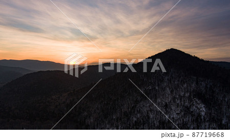 Aerial drone view in mountain forest. Winter landscape. Snowy Fir and Pine trees. Snowy tree branch in a view of the winter forest. Winter landscape, forest, trees covered with frost, snow. Aerial drone view in mountain forest. Winter landscape. Snowy Fir and Pine trees. Snowy tree branch in a view of the winter forest. Winter landscape, forest, trees covered with frost, snow. 87719668