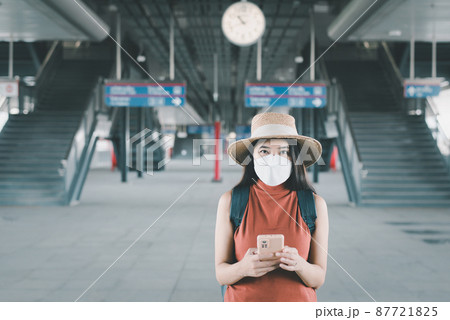 Women traveler using mobile phone during waiting train at train station,Travel and vacation concept Women traveler using mobile phone during waiting train at train station,Travel and vacation concept 87721825