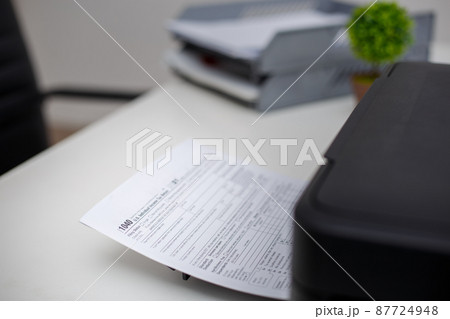 Tax documents are being printed from the printer, Tax payment concept, State Government taxation, Forms government, Paperwork, Report. Tax documents are being printed from the printer, Tax payment concept, State Government taxation, Forms government, Paperwork, Report. 87724948