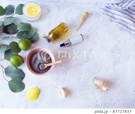 Blue clay, citruses, cream, aromatic oil, healthy tinctures and seashells on a light background, spa, natural ingredients, body care 87727837