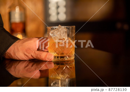 お酒を楽しむ男性の手元　BAR 87728130