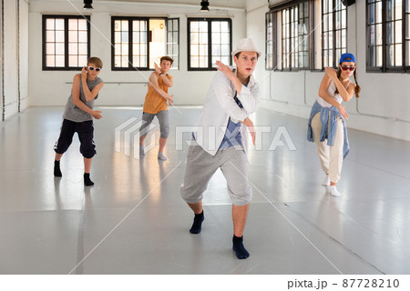 Group teenagers dancing hip-hop indoors 87728210