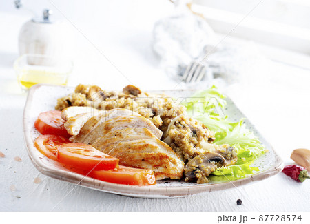 Chicken breast with fried mushrooms on plate 87728574