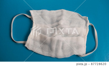 Surgical mask isolated on blue background Surgical mask isolated on blue background 87728620