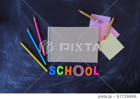 Pencils, paper and sketchbook on chalkboard background, top view, copy space, back to school Pencils, paper and sketchbook on chalkboard background, top view, copy space, back to school 87728666