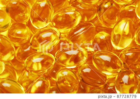 Golden Vitamin D3 Capsules close-up in full screen 87728779