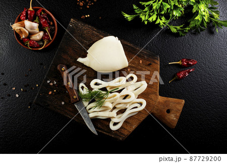 Slicing of boiled calamar on a cook-table 87729200